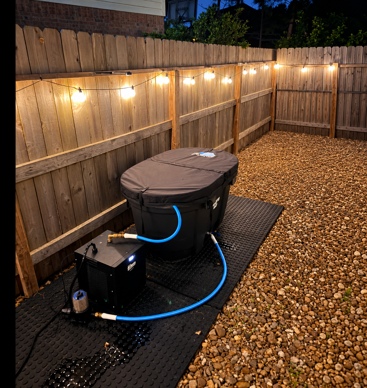 Rigid PlungeTX cold plunge tub and chiller set up in a Houston backyard at night with string lights